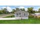 Charming single-story home with a covered front porch, well-maintained lawn, and newly installed driveway at 1423 Venetia St, Nokomis, FL 34275