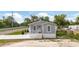 Charming single-story home with a covered front porch, well-maintained lawn, and newly installed driveway at 1423 Venetia St, Nokomis, FL 34275