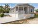 Charming single-story home with a covered front porch and well-maintained lawn and newly installed driveway at 1423 Venetia St, Nokomis, FL 34275
