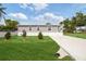 Single-story home with a covered front porch, manicured lawn and newly installed driveway at 1423 Venetia St, Nokomis, FL 34275