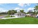 Well-maintained single-story home featuring a spacious front yard and covered porch at 1423 Venetia St, Nokomis, FL 34275