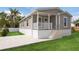 Charming single-story home with a covered front porch and well-maintained lawn and newly installed driveway at 1423 Venetia St, Nokomis, FL 34275