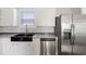 Modern kitchen featuring a stainless steel refrigerator and a farmhouse sink at 1423 Venetia St, Nokomis, FL 34275