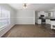 Open living area with plush carpet, view to kitchen with modern appliances at 1423 Venetia St, Nokomis, FL 34275