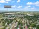 Aerial view showcasing the home's location near Honeymoon Island State Park, surrounded by trees at 1531 Picardy Cir, Clearwater, FL 33755