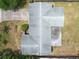 Aerial view of the home featuring a well-maintained roof, landscaped yard and adjacent driveway at 1531 Picardy Cir, Clearwater, FL 33755