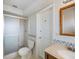 Bathroom featuring a walk-in shower, single sink vanity, and decorative tile at 1531 Picardy Cir, Clearwater, FL 33755
