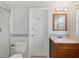 Updated bathroom with walk-in shower, single sink vanity and decorative tile accents at 1531 Picardy Cir, Clearwater, FL 33755