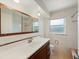 Bright bathroom featuring a large sink vanity, mirrored medicine cabinet, and tiled shower/tub combo at 1531 Picardy Cir, Clearwater, FL 33755