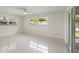 Light and airy bedroom with polished floors and two windows offering natural light at 1531 Picardy Cir, Clearwater, FL 33755