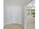 The house's entrance features a white front door, and a view to a living space at 1531 Picardy Cir, Clearwater, FL 33755