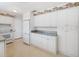 A kitchen with white cabinets, countertops and appliances at 1531 Picardy Cir, Clearwater, FL 33755