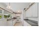 The kitchen has white cabinets and gray countertops at 1531 Picardy Cir, Clearwater, FL 33755