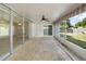 Covered patio featuring tile flooring, glass sliding doors and screens, leading to outdoor living at 1531 Picardy Cir, Clearwater, FL 33755