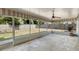 Covered lanai featuring a patterned ceiling fan and screen enclosure overlooking the backyard at 1531 Picardy Cir, Clearwater, FL 33755