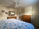 Comfortable bedroom with soft lighting, a ceiling fan, and matching wood furniture at 1710 7Th Sw St # 24, Ruskin, FL 33570