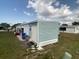 Home exterior featuring covered entry, adjacent carport and garden at 1710 7Th Sw St # 24, Ruskin, FL 33570