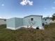 Exterior shot showing vinyl siding and window air conditioner at 1710 7Th Sw St # 24, Ruskin, FL 33570