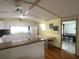 Bright kitchen featuring white cabinets, laminate countertops, and a light wood floor and table with a butcher block top at 1710 7Th Sw St # 24, Ruskin, FL 33570