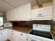 Close-up of a kitchen featuring white cabinets and laminate countertops and a white range at 1710 7Th Sw St # 24, Ruskin, FL 33570