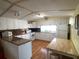 Bright kitchen featuring white cabinets, laminate countertops, and a light wood floor and table with a butcher block top at 1710 7Th Sw St # 24, Ruskin, FL 33570