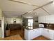 Open concept living room with a laminate floor, ceiling fan, and brown sofa, with the kitchen in the foreground at 1710 7Th Sw St # 24, Ruskin, FL 33570