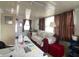 Small living room featuring a sofa, desk, and a window with privacy curtains at 1710 7Th Sw St # 24, Ruskin, FL 33570
