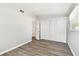 This bedroom has wood-look floors, a double-door closet, and neutral paint at 1764 St Croix Dr, Clearwater, FL 33759