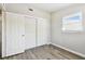 Bedroom featuring gray walls, wood-look floors, and sliding-door closet at 1764 St Croix Dr, Clearwater, FL 33759
