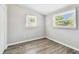 Cozy bedroom features light gray walls, modern flooring, and ample natural light at 1764 St Croix Dr, Clearwater, FL 33759