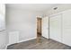 Bedroom featuring gray walls, wood-look floors, and double sliding-door closet at 1764 St Croix Dr, Clearwater, FL 33759