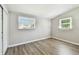 This bedroom features modern light gray walls, wood-look flooring, and natural light at 1764 St Croix Dr, Clearwater, FL 33759