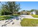 Exterior view of house with long driveway and green lawn at 1764 St Croix Dr, Clearwater, FL 33759