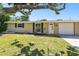 Charming single-story home with a well-manicured lawn and mature landscaping at 1764 St Croix Dr, Clearwater, FL 33759