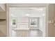 Cozy living room with a white-painted brick fireplace and updated flooring and a white ceiling at 1764 St Croix Dr, Clearwater, FL 33759