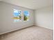 Comfortable bedroom with neutral carpet, and two windows offer a calming view of the lake and landscaping at 17800 Solstice Ave, Venice, FL 34293