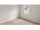 Cozy bedroom with neutral carpet and a single window allowing natural light at 17800 Solstice Ave, Venice, FL 34293