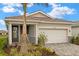 Beautiful single-Gathering home featuring a two-car garage, manicured landscaping, and a classic tile roof at 17800 Solstice Ave, Venice, FL 34293