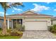 Charming single-Gathering home featuring a two-car garage, beautiful landscaping, and a classic tile roof at 17800 Solstice Ave, Venice, FL 34293