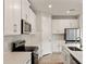 Well-equipped kitchen features stainless steel appliances, white cabinets, and ample counter space at 17800 Solstice Ave, Venice, FL 34293