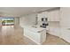 Spacious kitchen with an island, stainless steel appliances, and a view of the living area at 17800 Solstice Ave, Venice, FL 34293