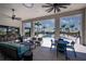 Inviting outdoor lounge area featuring comfortable seating, a bar, and views of the pool at 17800 Solstice Ave, Venice, FL 34293