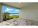 Covered patio featuring brick flooring with a scenic view of a pond and landscaped backyard at 17800 Solstice Ave, Venice, FL 34293