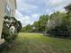 A backyard area showing lush landscaping and a dark green perimeter fence at 18267 Bridle Club Dr, Tampa, FL 33647