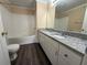Bright bathroom featuring double sinks with granite countertops and a tub with shower at 18267 Bridle Club Dr, Tampa, FL 33647