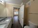 Bright bathroom featuring a granite vanity and wood-look flooring at 18267 Bridle Club Dr, Tampa, FL 33647