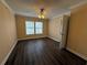 Bright bedroom with wood floors, neutral walls, ceiling fan and natural light from windows at 18267 Bridle Club Dr, Tampa, FL 33647