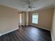 Bedroom featuring wood flooring, an adjacent window, and interior door at 18267 Bridle Club Dr, Tampa, FL 33647