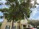 A low angle shot of a traditional condo featuring mature trees and serene setting at 18267 Bridle Club Dr, Tampa, FL 33647