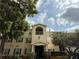 Traditional condo building featuring a balcony, manicured landscaping, and a serene setting at 18267 Bridle Club Dr, Tampa, FL 33647